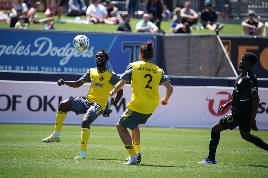 Kenardo Forbes controls the ball while Nate Dossantos looks on in the Riverhounds 4-3 win at FC Tulsa on April 9, 2022.