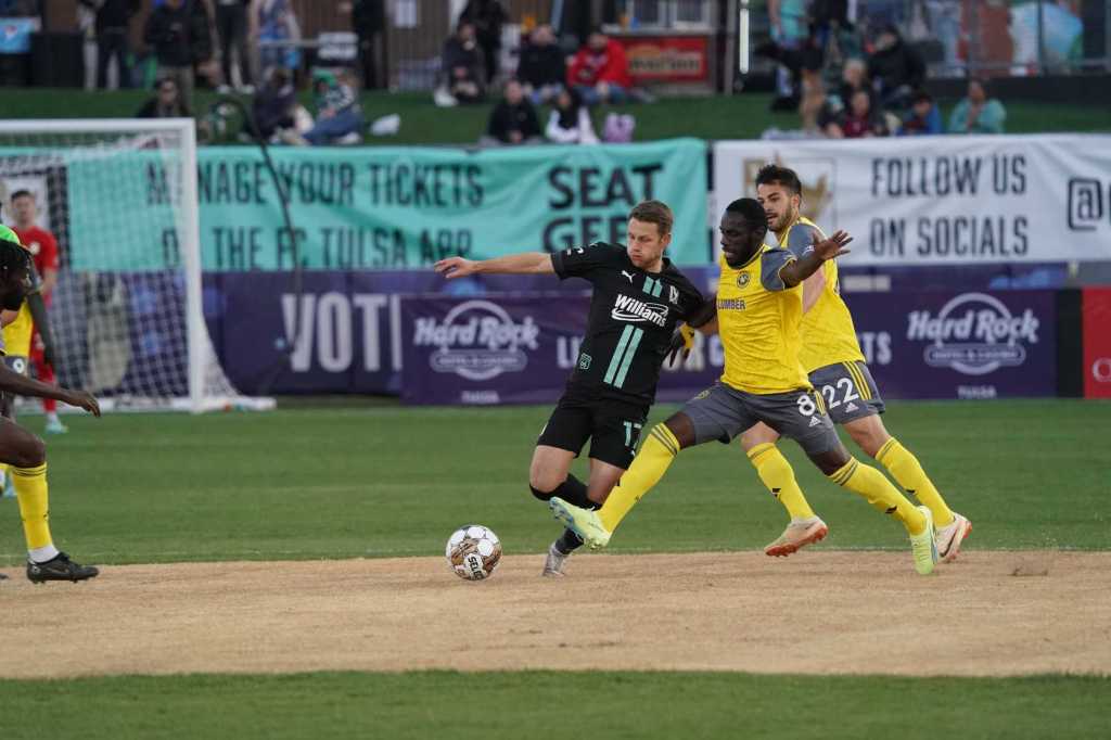 Junior Etou battles Tulsa's Brett Levis for the ball during the Riverhounds' 0-0 draw on Tuesday, March 28 at ONEOK Field in Tulsa, Okla.