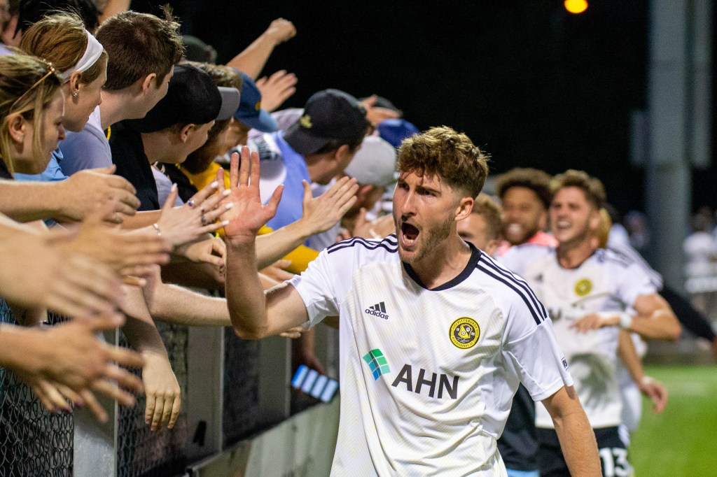 Pat Hogan celebrates with fans after the Riverhounds' 1-0 win over the Columbus Crew in the U.S. Open Cup on May 24, 2023 at Highmark Stadium.