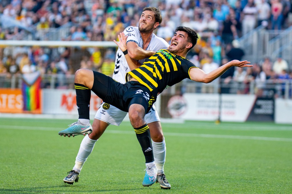 Marc Ybarra gets pulled back by the Charleston Battery's Deklan Wynne during the Riverhounds' 2-0 win over Battery on June 10, 2023 at Highmark Stadium.
