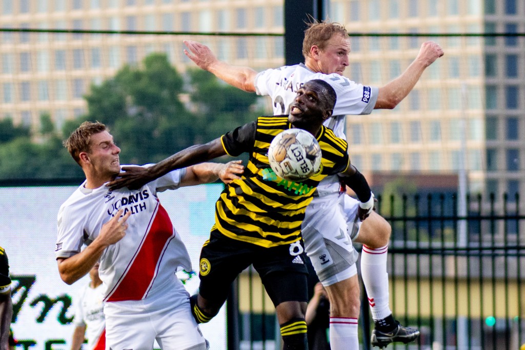 Junior Etou gets squeezed out by a pair of Sacramento Republic players in the Hounds' 0-0 draw at Highmark Stadium on July 8, 2023.