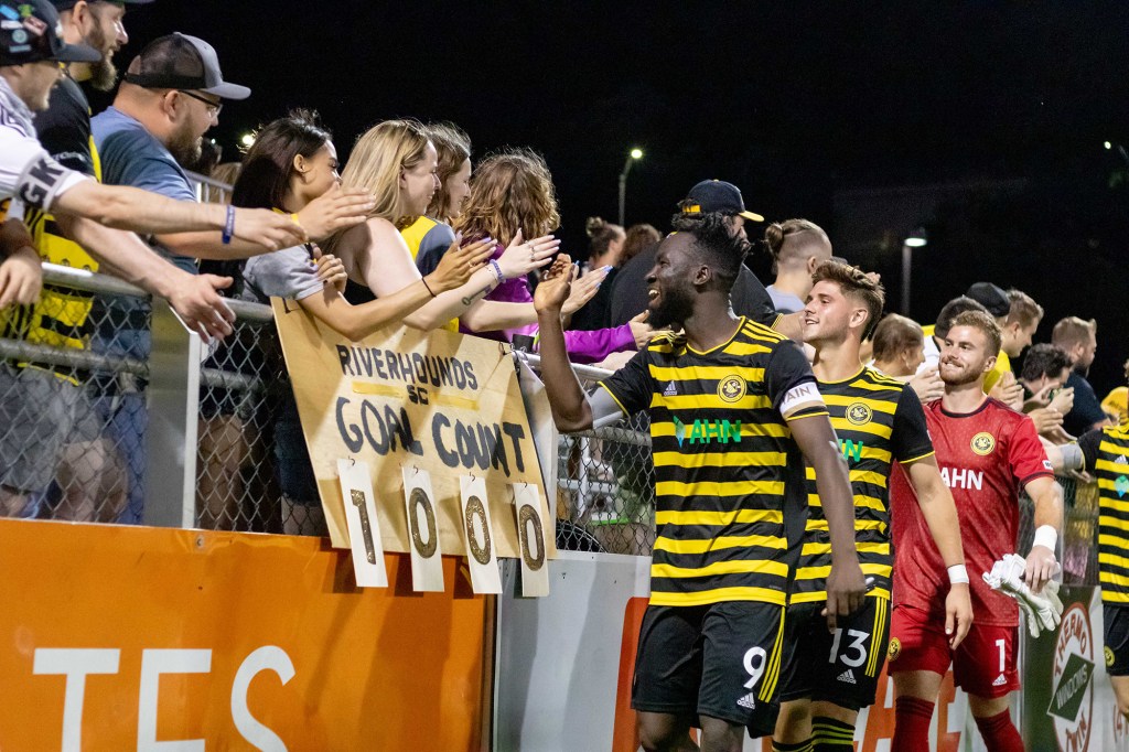 Pittsburgh Riverhounds players celebrate with fans after a 4-2 win over Memphis 901 FC in which the team scored the 1,000th goal in club history on July 29, 2023 at Highmark Stadium.