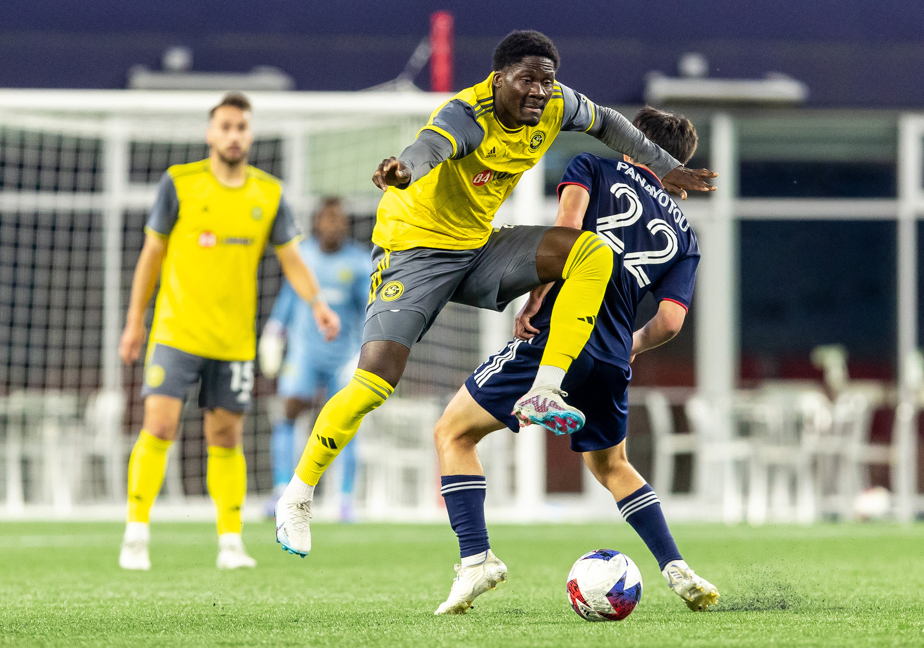 DZ Harmon hurdles the leg of a defender in the Riverhounds' 1-0 win over the New England Revolution in the U.S. Open Cup on May 9, 2023 at Gillette Stadium in Foxborough, Mass.