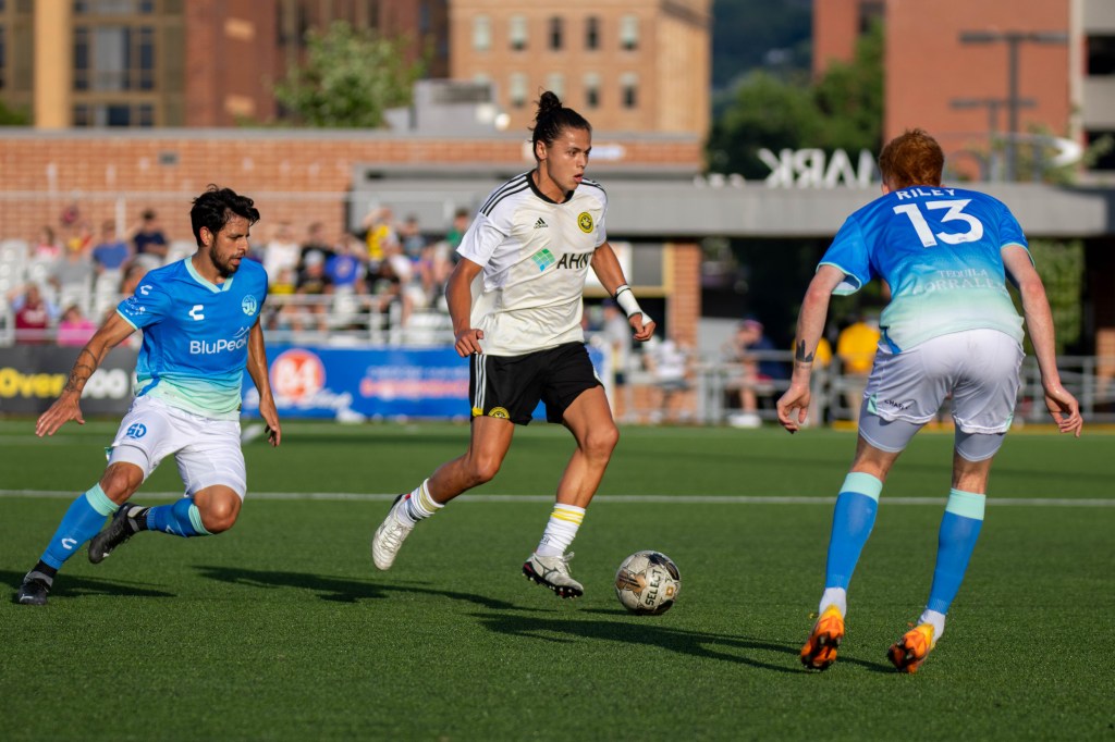 Nate Dossantos dribbles the ball between defenders in the Hounds' 2-1 win over San Diego Loyal on June 24, 2023 at Highmark Stadium.