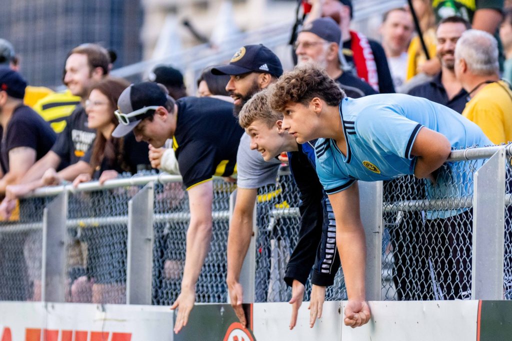Fans lean over the Supporters' Section railing during the Pittsburgh Riverhounds' 2-1 win over Loudoun United FC on Sept. 9, 2023 at Highmark Stadium.