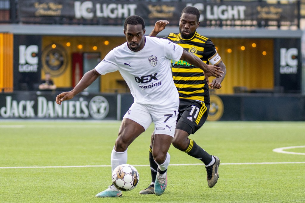 Pittsburgh Riverhounds midfielder Kenardo Forbes challenges for the ball against Tampa Bay Rowdies midfielder Yann Ekra during the Hounds' 1-0 win on Aug. 5, 2023 at Highmark Stadium.