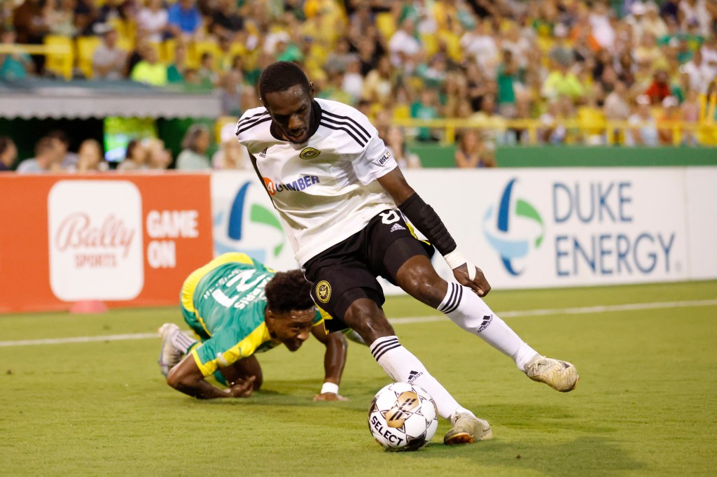 Riverhounds left back Junior Etou wins the ball from the Tampa Bay Rowdies' Dayonn Harris in the Hounds' 2-0 win on Oct. 7, 2023 at Al Lang Stadium in St. Petersburg, Fla.