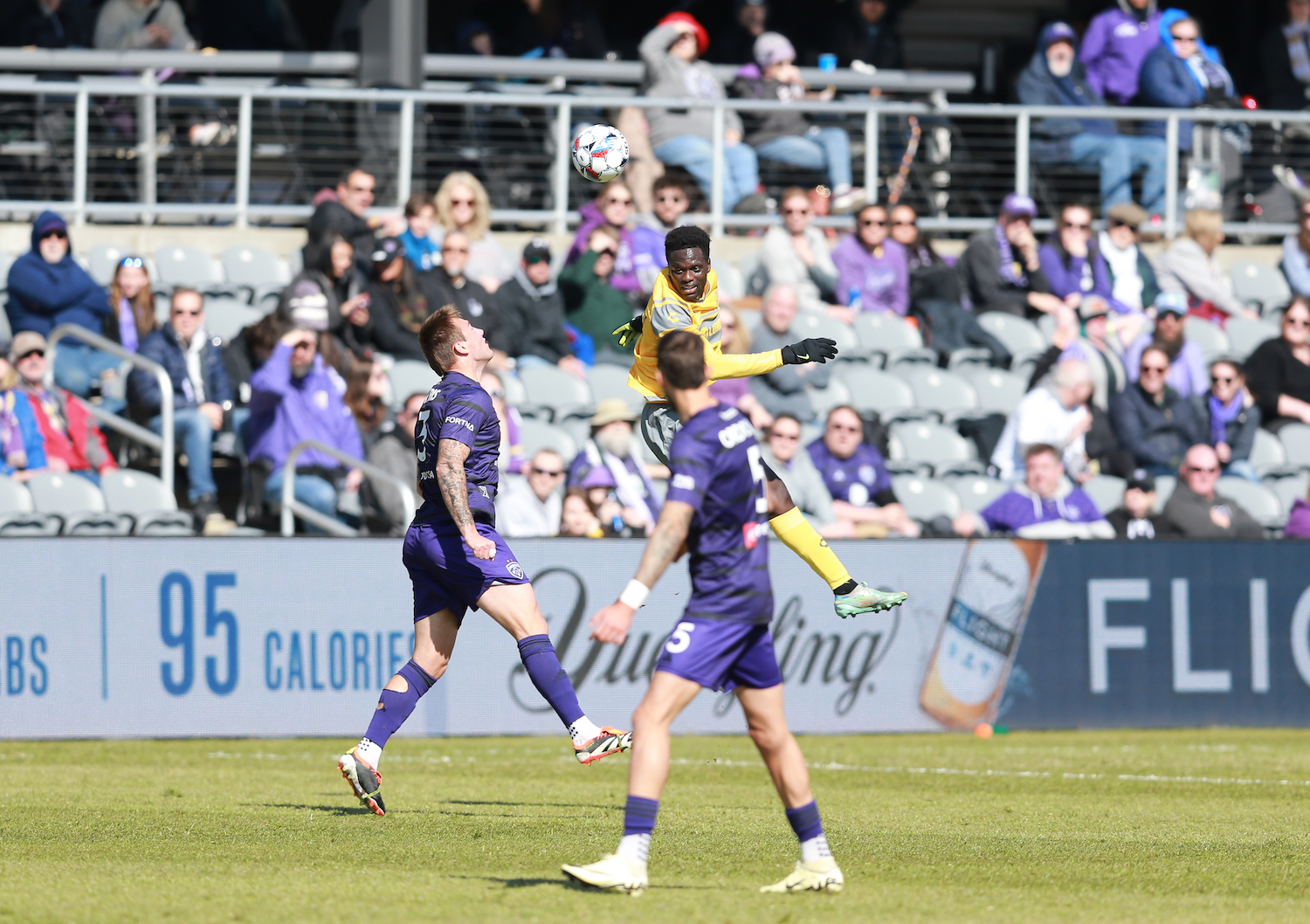Babacar Diene leaps to head the ball for the Riverhounds against Louisville City FC on March 23, 2024 at Lynn Family Stadium in Louisville, Ky.
