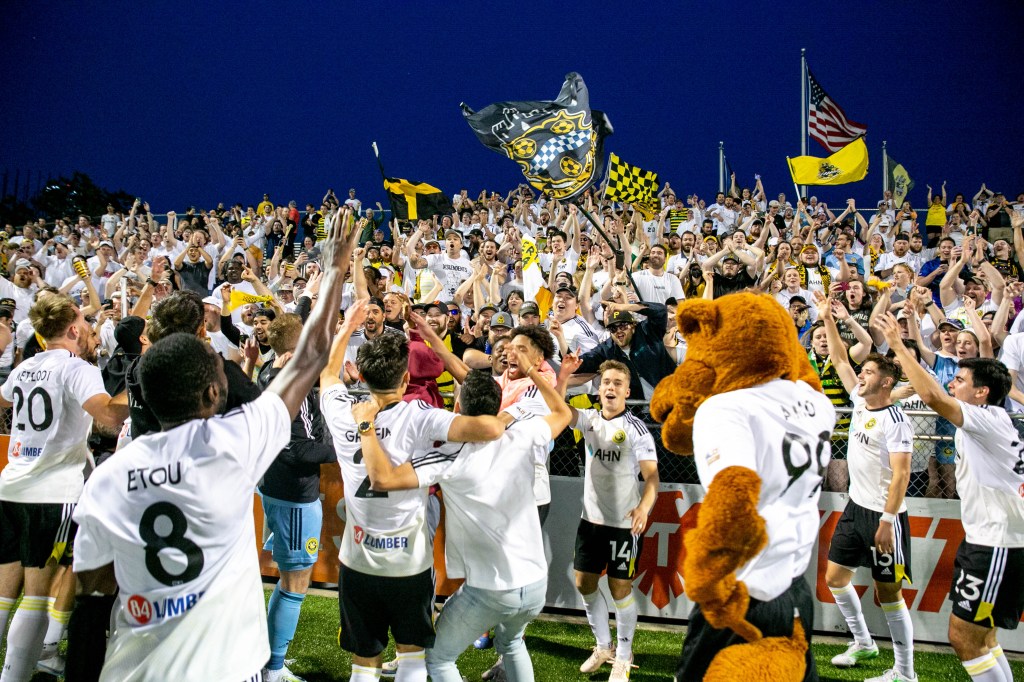 Riverhounds players celebrate with fans after defeating the Columbus Crew in the U.S. Open Cup Round of 16 in 2023. 