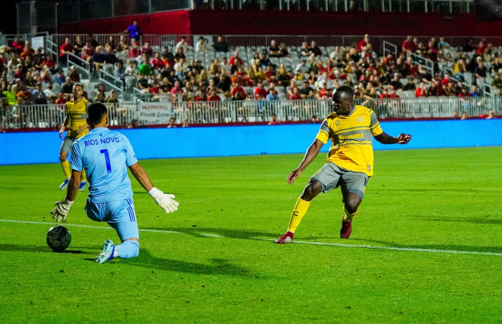 Edward Kizza scores in the Hounds' 3-1 win over Phoenix Rising FC on April 20, 2024 at Phoenix Rising Soccer Stadium.