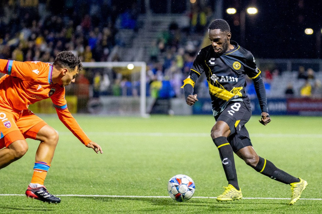 Hounds midfielder Junior Etou dribbles at his defender in the team's 1-0 win over Miami FC on May 4, 2024 at Highmark Stadium. (Photo: Chris Cowger/Riverhounds SC)