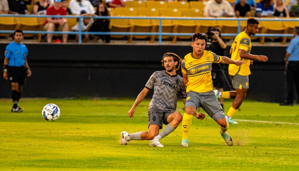 Pittsburgh Riverhounds player Danny Griffin challenging for the ball with Las Vegas' Gennaro Nigro in Las Vegas