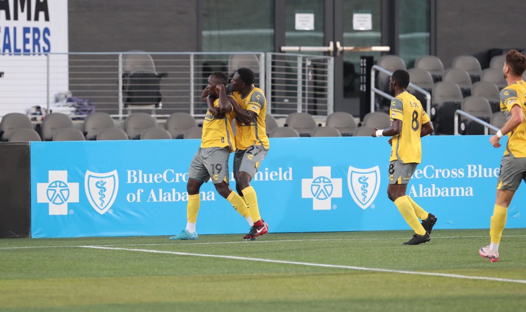 Babacar Diene hugs teammate Edward Kizza after a Kizza goal against the Birmingham Legion FC at Protective Stadium in Birmingham, Ala.