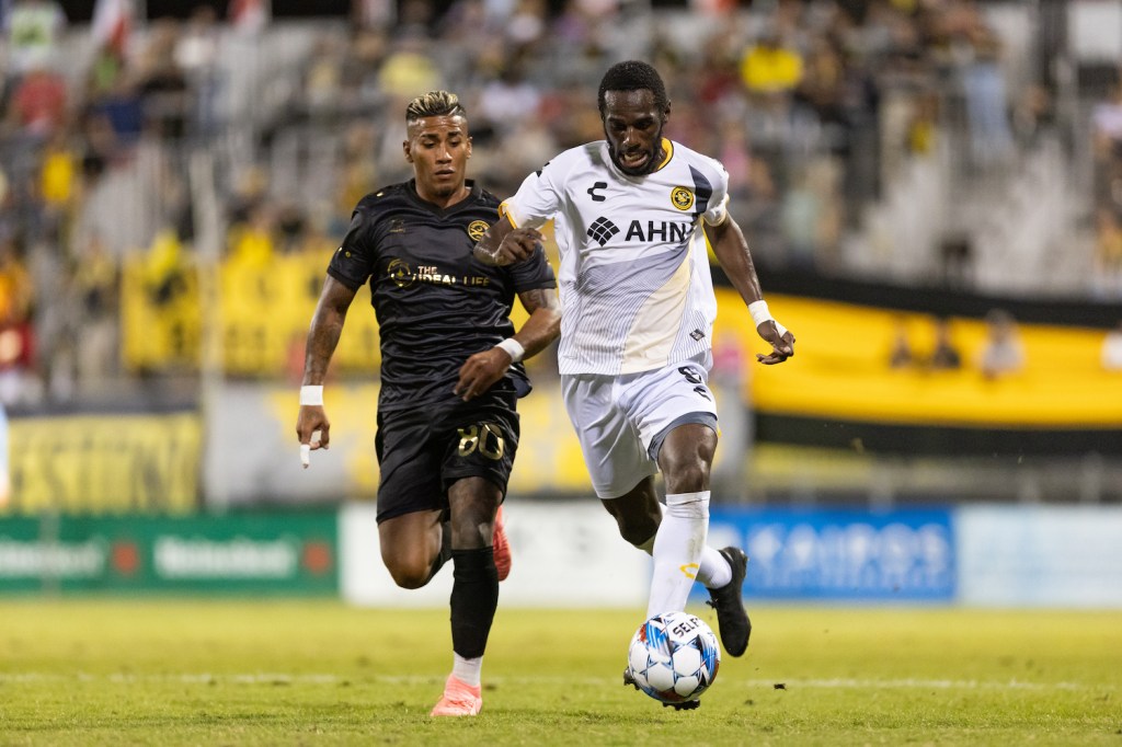 Pittsburgh Riverhounds wing back Junior Etou dribbles past Charleston Battery midfielder Juan Torres in the at Patriots Point Soccer Complex in Mount Pleasant, S.C.