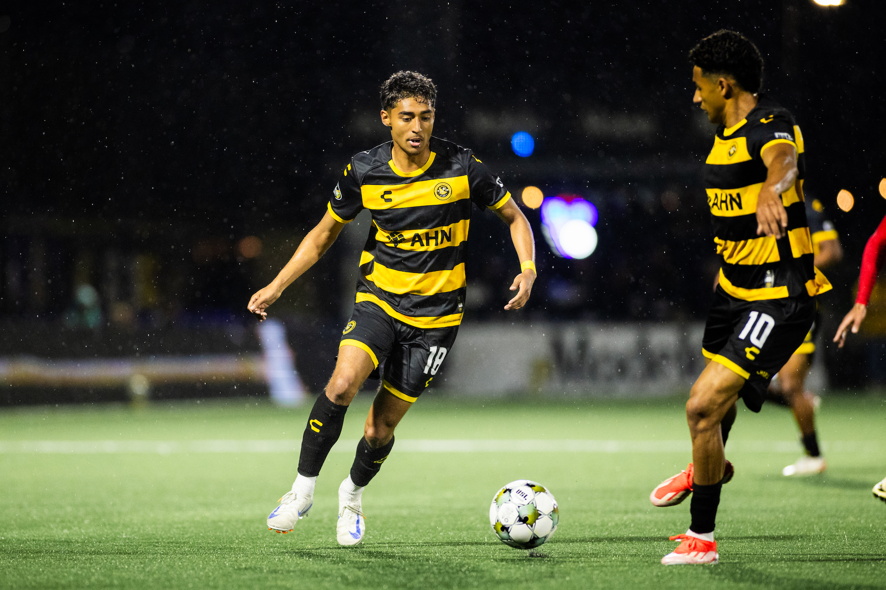Jorge Garcia tees up a shot as Bertin Jacquesson looks on during the Riverhounds match against North Carolina FC on May 3, 2025 at Highmark Stadium. (Photo: Ryan Shaffer/Riverhounds SC)