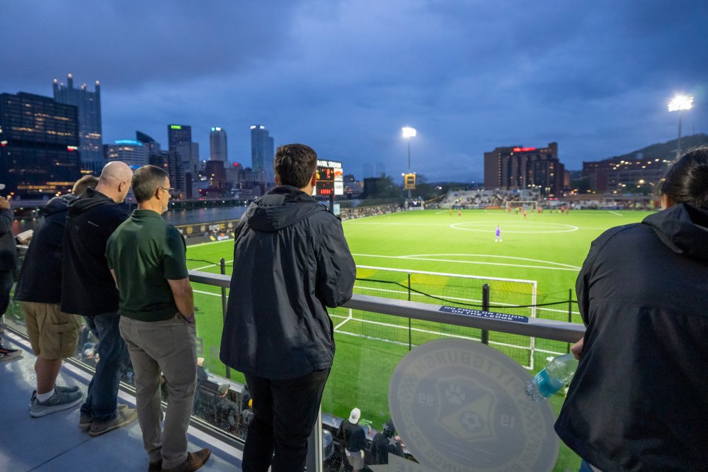 Guests watch a Riverhounds match from a premium stadium balcony