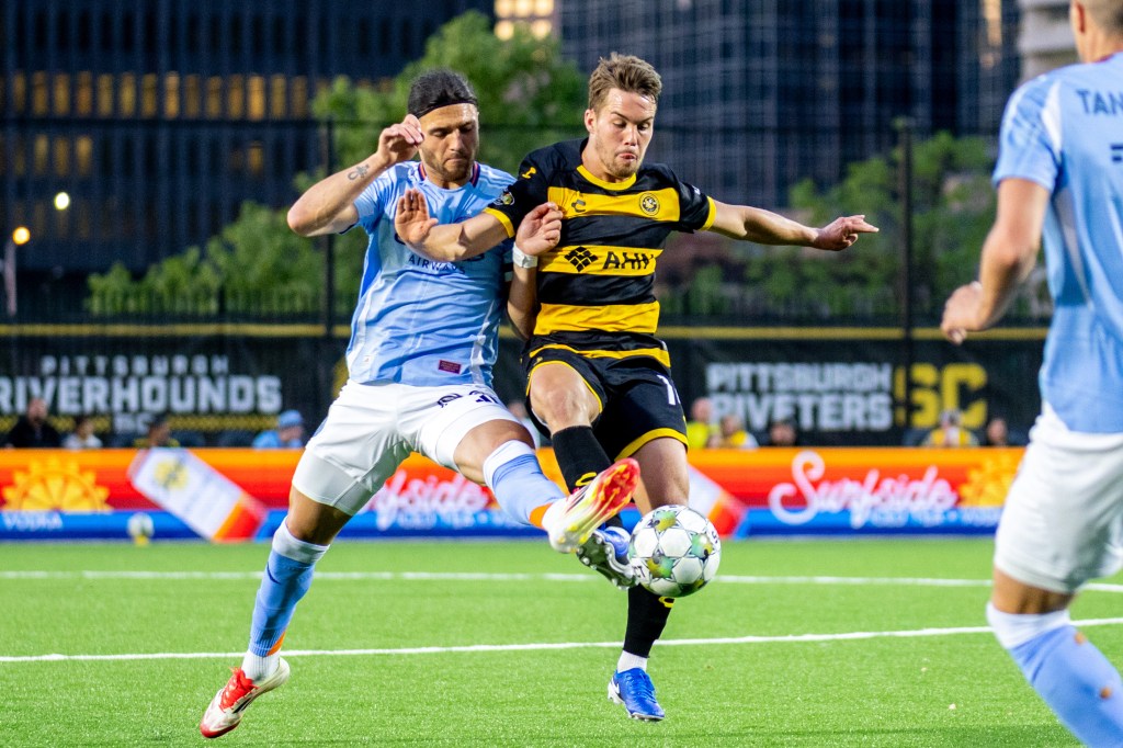 Robbie Mertz battles New York City FC's Justin Haak for the ball in the Riverhounds' 1-0 U.S. Open Cup win May 7, 2025 at Highmark Stadium in Pittsburgh. (Photo: Chris Cowger/Riverhounds SC)