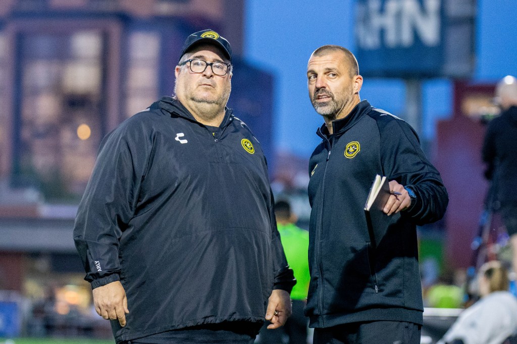 Riverhounds head coach Bob Lilley listens to assistant Jon Busch during the team's 1-0 win over New York City FC in the U.S. Open Cup Round of 32 on May 7, 2025 at Highmark Stadium. (Photo: Chris Cowger/Riverhounds SC)