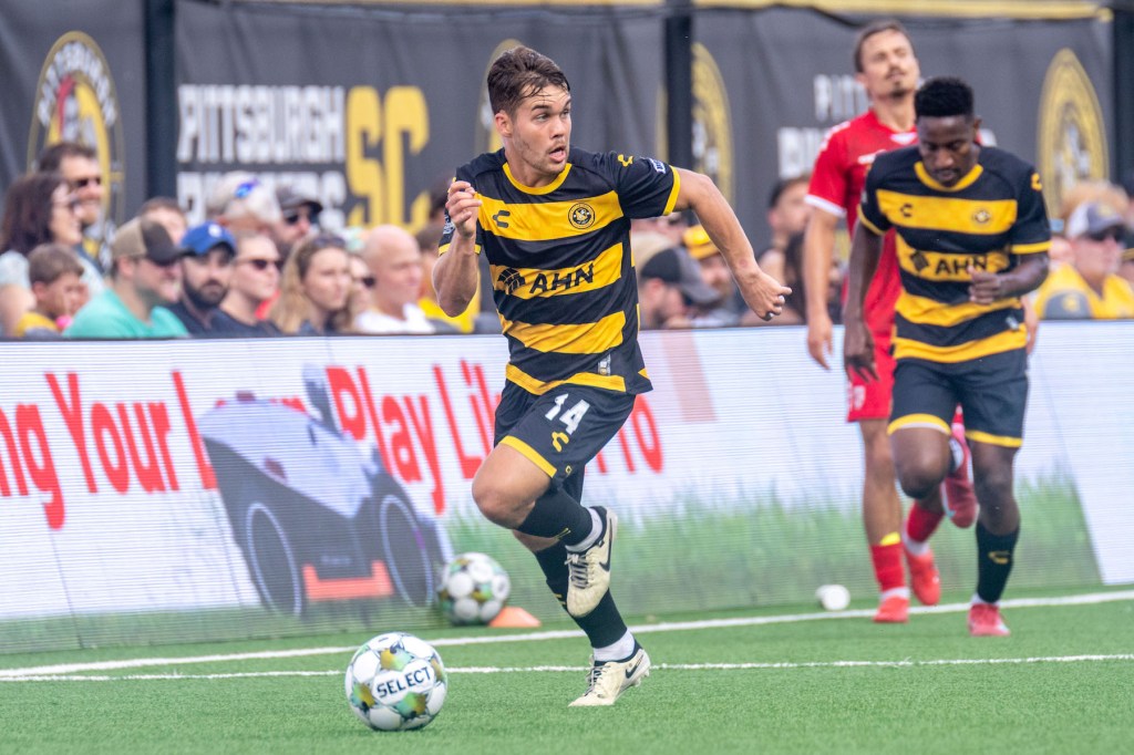 Pittsburgh Riverhounds midfielder Robbie Mertz looks up as he dribbles forward in the team's 2-2 draw with Loudoun United FC on July 13, 2025 at Highmark Stadium in Pittsburgh. (Photo: Chris Cowger/Riverhounds SC)