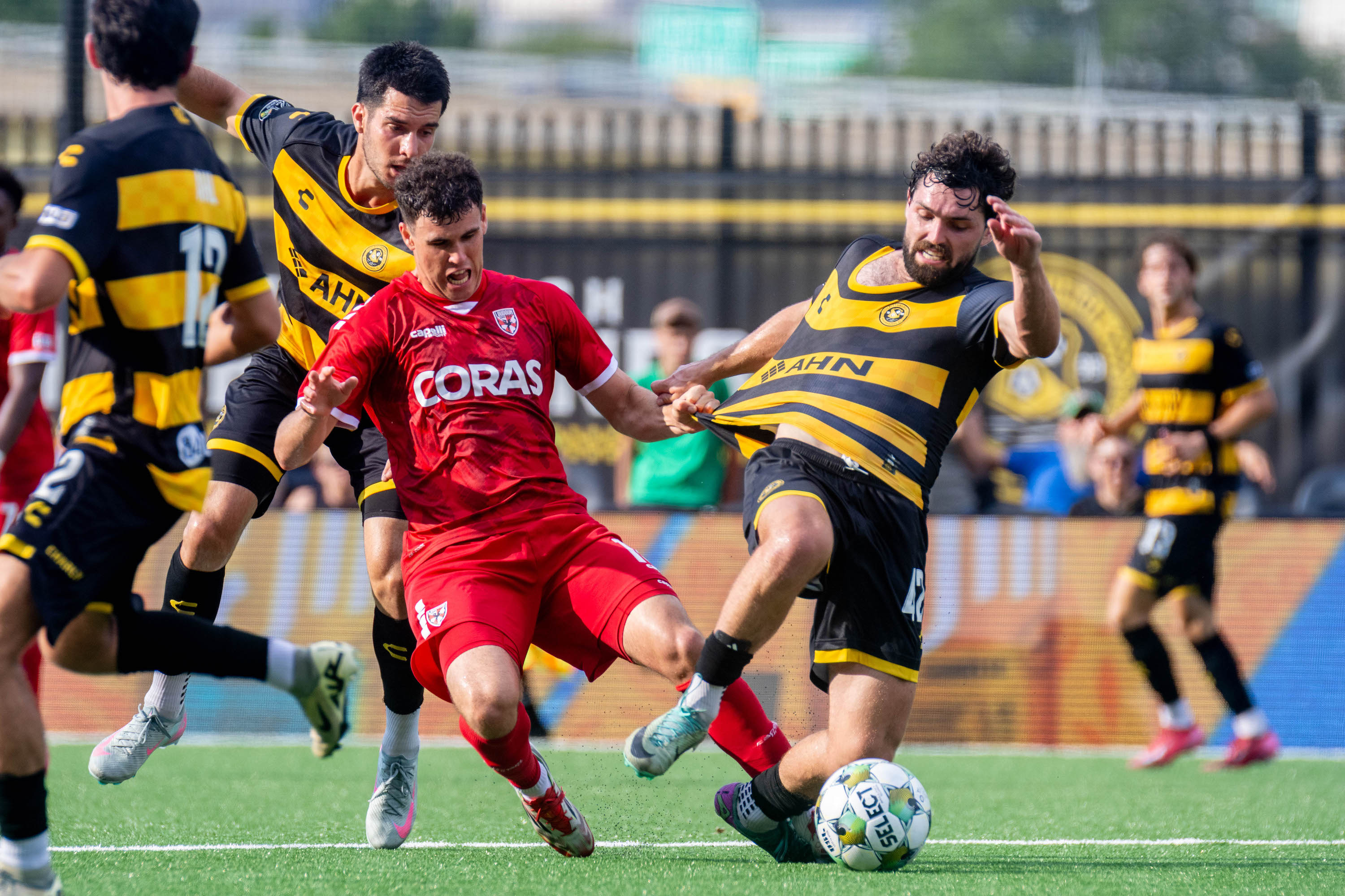 Jackson Walti wins the ball for the Pittsburgh Riverhounds despite a tug of the shirt from Loudoun United FC's Riley Bidois in the 2-2 draw between the teams on July 13, 2025 at Highmark Stadium in Pittsburgh (Photo: Chris Cowger/Riverhounds SC)