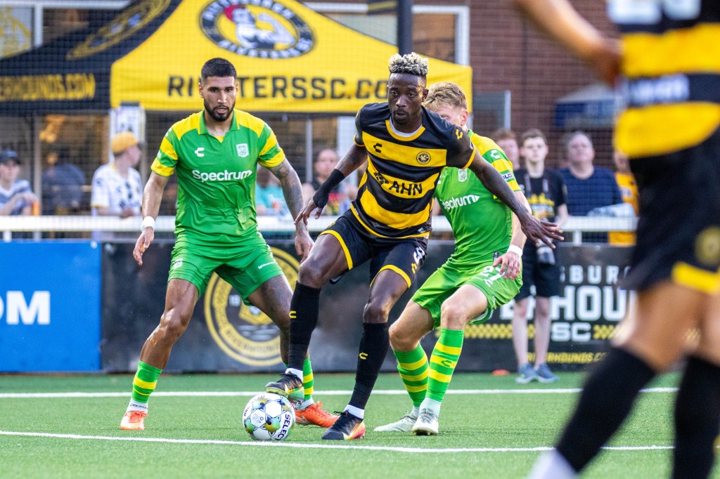 Augi Williams controls the ball in front of a pair of Tampa Bay Rowdies defenders in the Pittsburgh Riverhounds' 2-1 win on June 21, 2025 at Highmark Stadium in Pittsburgh. (Photo: Chris Cowger/Riverhounds SC)