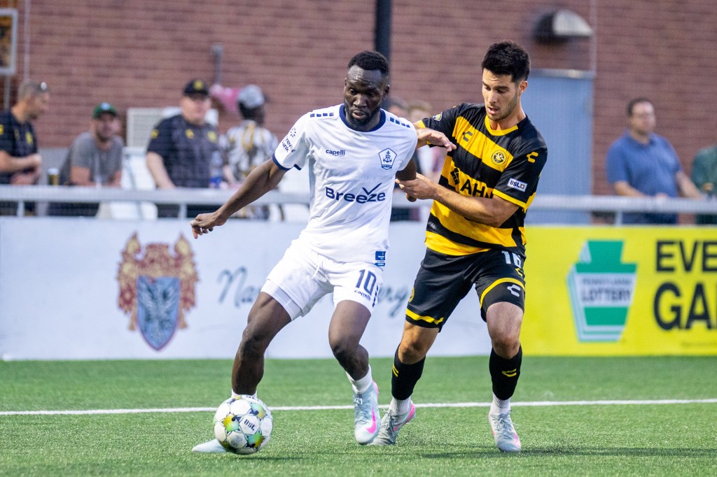 Riverhounds defender Beto Ydrach stays tight to Rhode Island FC forward Albert Dikwa in the Hounds' 2-0 win on Aug. 2, 2025 at Highmark Stadium in Pittsburgh. (Photo: Chris Cowger/Riverhounds SC)