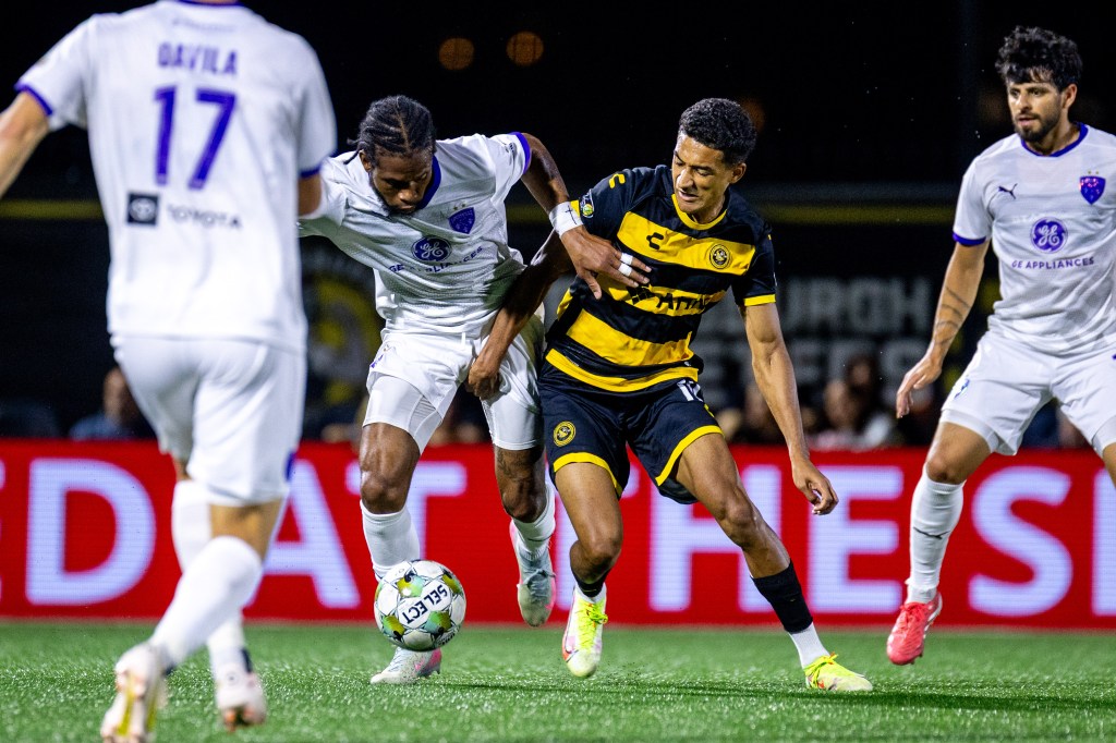 The Pittsburgh Riverhounds' Bertin Jacquesson (right) and Louisville City FC's Kevon Lambert battle for the ball in the teams' match Sept. 13, 2025 at Highmark Stadium in Pittsburgh. (Photo: Chris Cowger/Riverhounds SC)