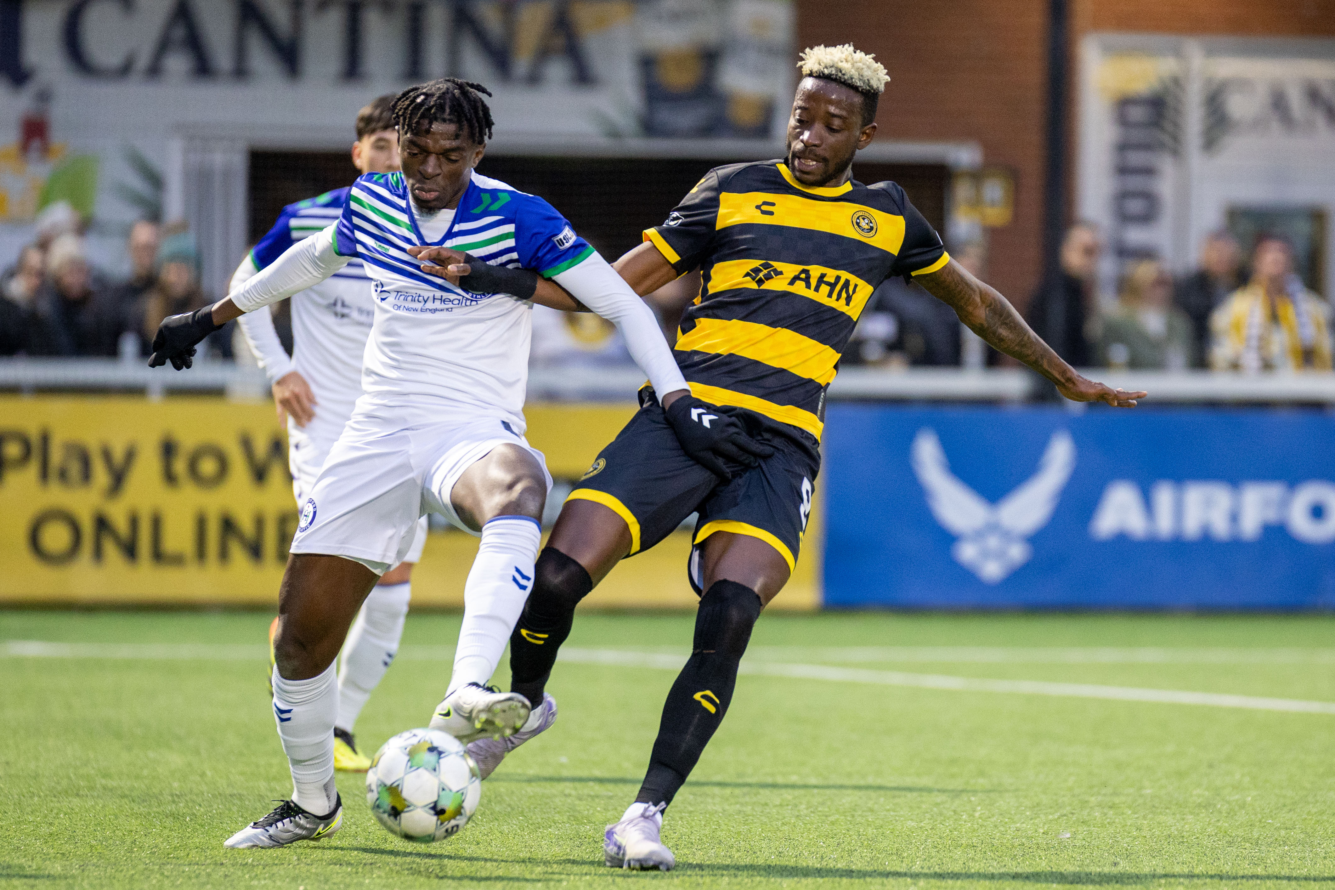 Pittsburgh Riverhounds striker Augi Williams battles for the ball with Hartford Athletic's Beverly Makangila in the Hounds' 1-0 win on March 22, 2025 at Highmark Stadium in Pittsburgh. (Photo: Chris Cowger/Riverhounds SC)