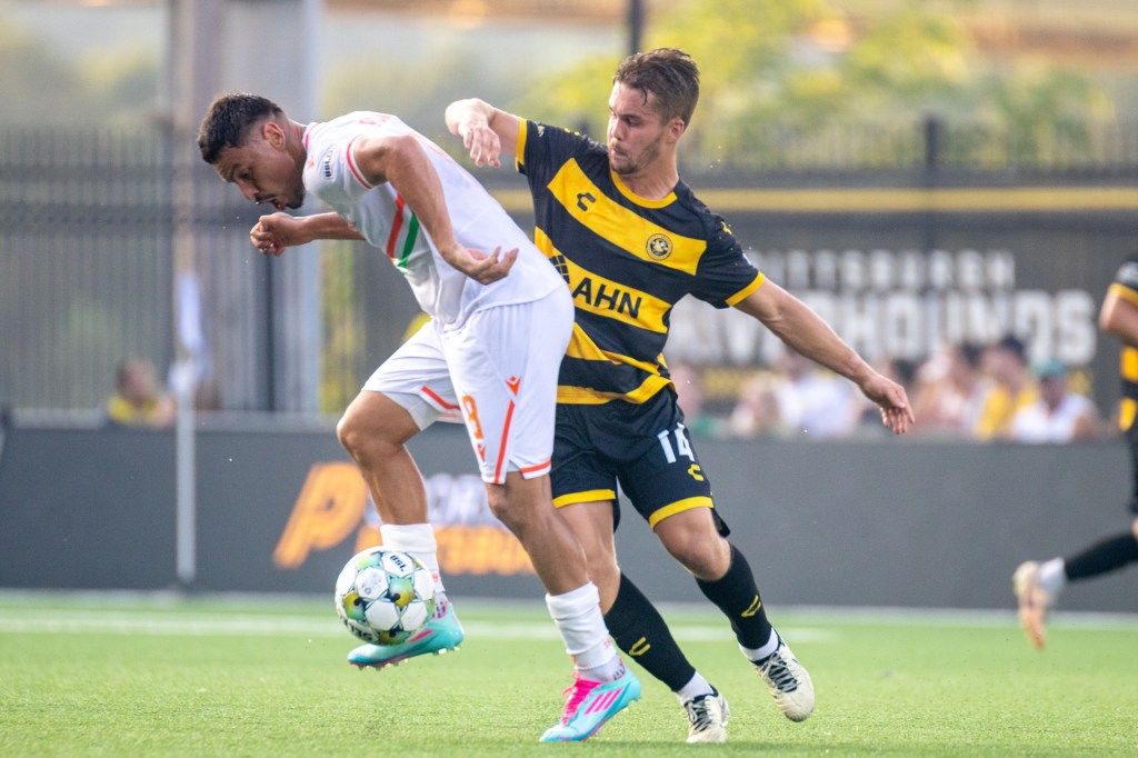 Pittsburgh Riverhounds SC's Robbie Mertz (right) battles for the ball with Miami FC's Matías Romero in the teams' match July 29, 2025 at Highmark Stadium in Pittsburgh. (Photo: Chris Cowger/Riverhounds SC)