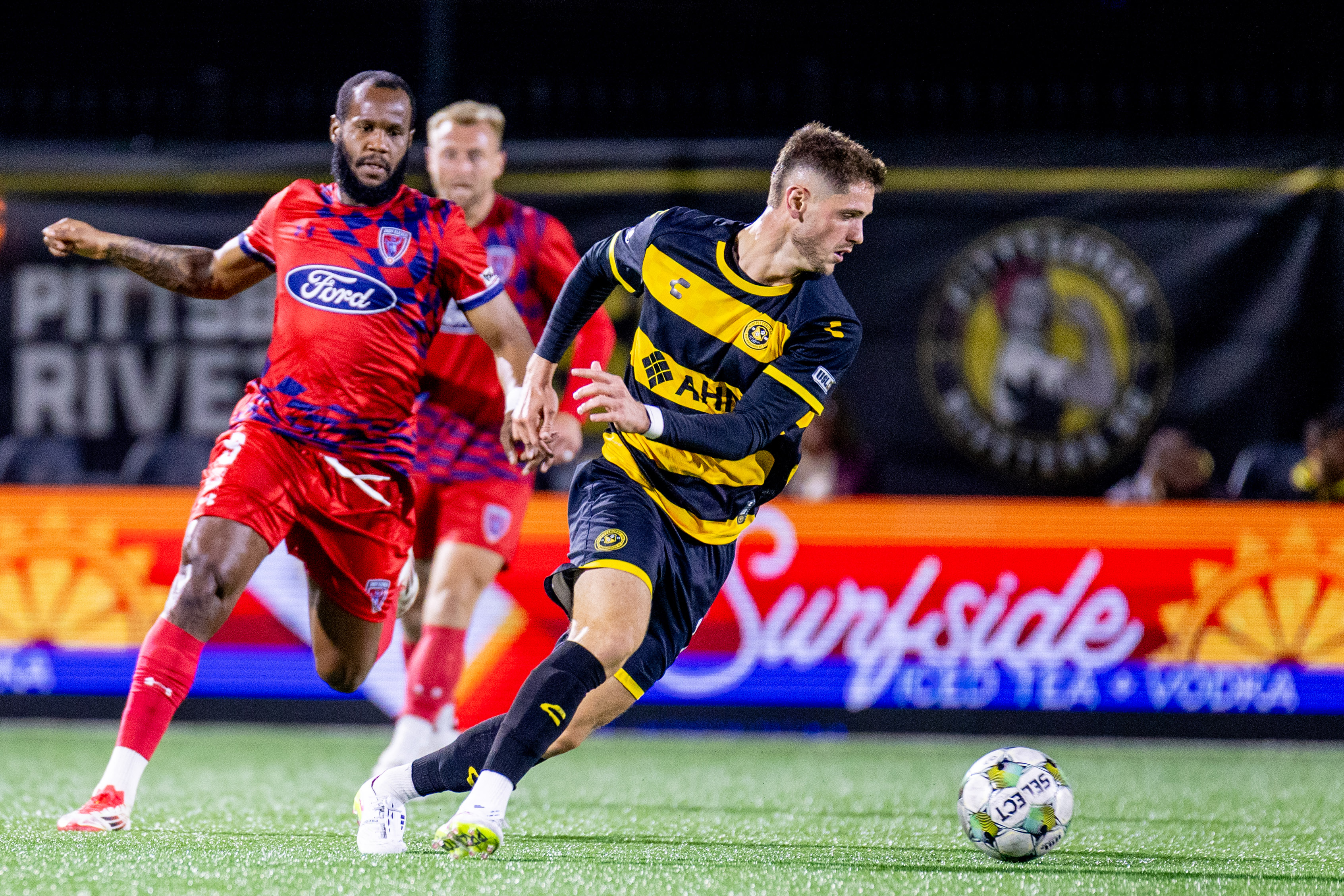 Luke Biasi turns away from a pair of Indy Eleven defenders in the Pittsburgh Riverhounds' 2-1 win on Oct. 11, 2025 at Highmark Stadium in Pittsburgh. (Photo: Chris Cowger/Riverhounds SC)