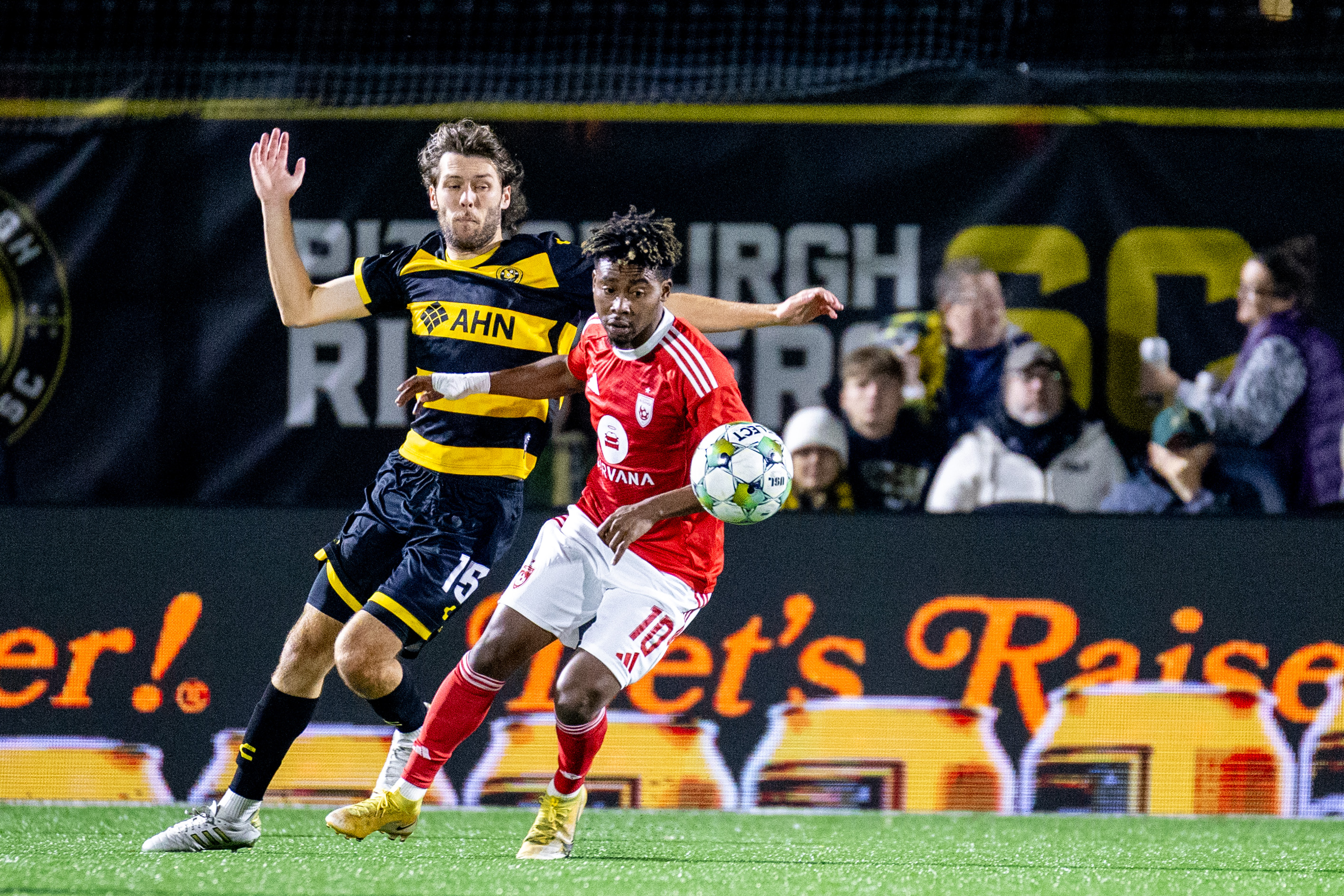 Bradley Sample tries to get around Phoenix Rising FC's Hope Avayevu in the Pittsburgh Riverhounds' 0-0 draw on Oct. 25, 2025 at Highmark Stadium in Pittsburgh. (Photo: Chris Cowger/Riverhounds SC)