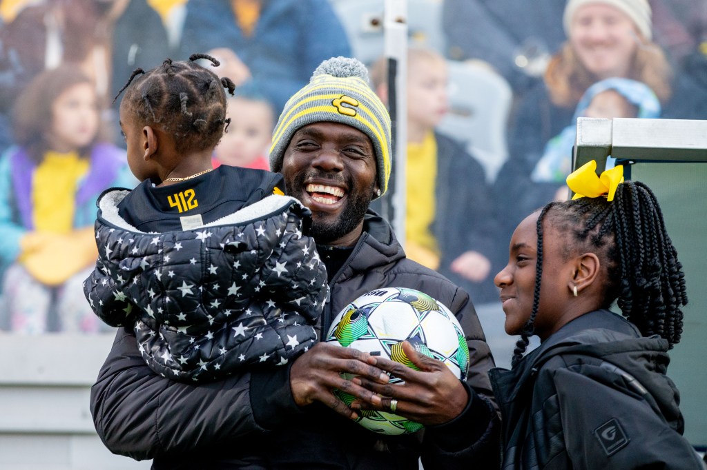 Kenardo Forbes laughs with his children before his pre-match retirement ceremony before the Riverhounds match March 22, 2025 at Highmark Stadium in Pittsburgh. (Photo: Chris Cowger/Riverhounds SC)