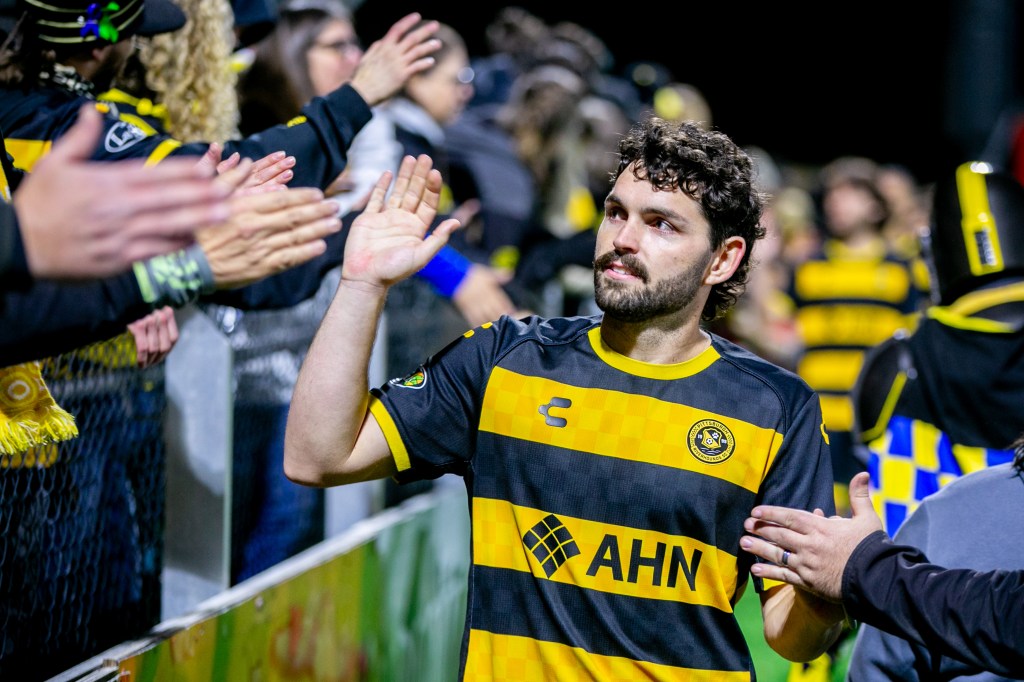 Pittsburgh Riverhounds midfielder Jackson Walti gives high fives to fans after the team's match against Phoenix Rising FC on Oct. 25, 2025 at Highmark Stadium in Pittsburgh. (Photo: Chris Cowger/Riverhounds SC)