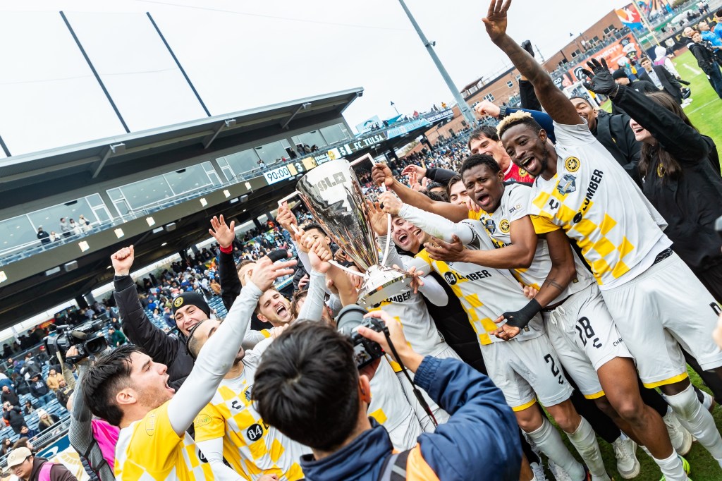 Pittsburgh Riverhounds players celebrate with the trophy after winning the USL Championship Final on Nov. 22 at ONEOK Field in Tulsa, Okla. (Photo: Mallory Neil/Riverhounds SC)
