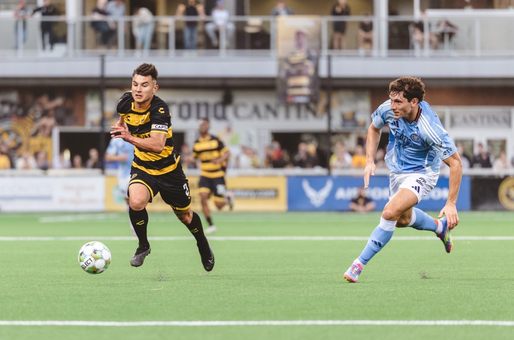 Pittsburgh Riverhounds captain Danny Griffin dribbles past New York City FC's Nico Cavallo in the Hounds' 1-0 U.S. Open Cup win on May 7, 2025 at Highmark Stadium in Pittsburgh. (Photo: Ryan Shaffer/Riverhounds SC)