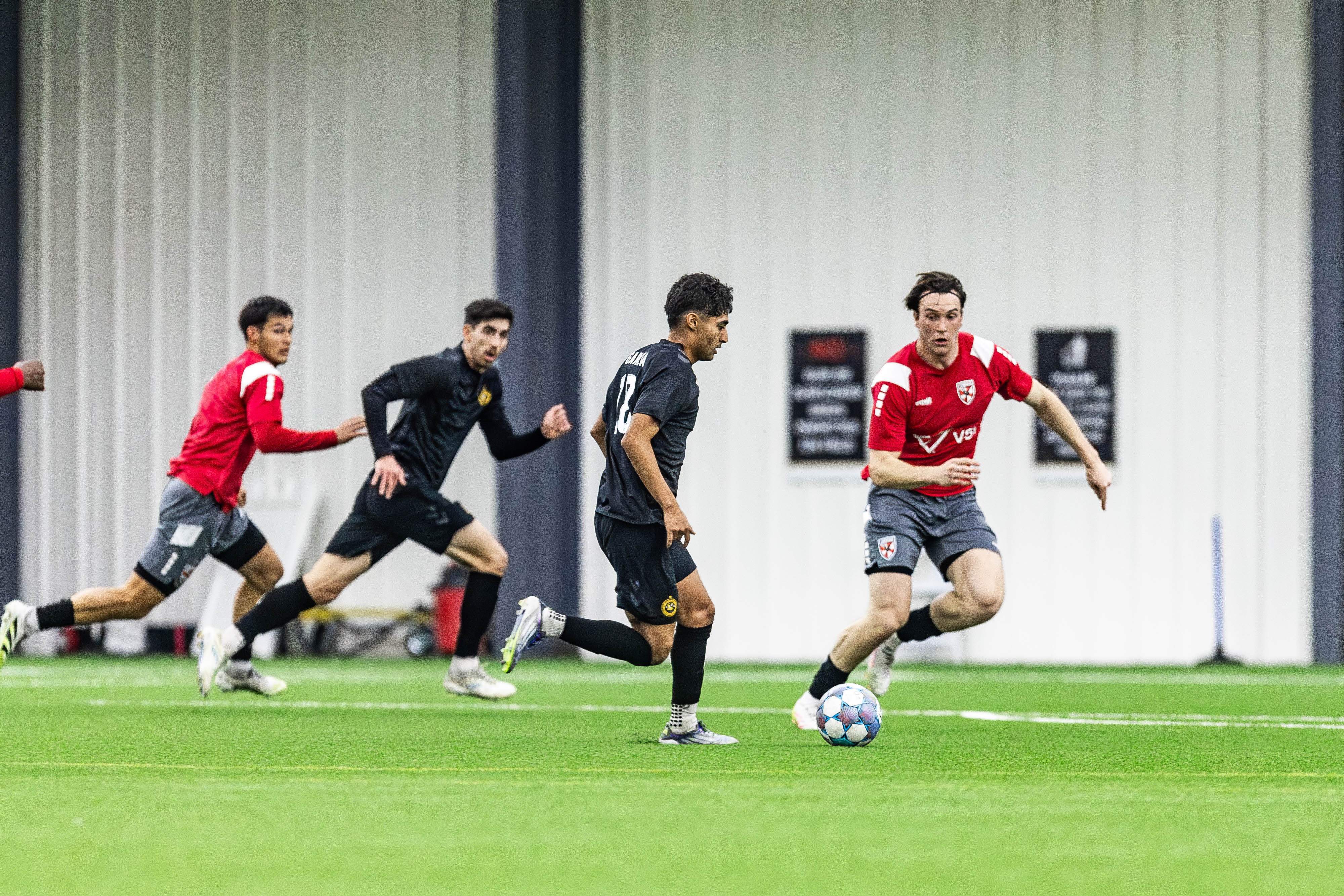 Pittsburgh Riverhounds midfielder Jorge Garcia dribbles toward goal while Trevor Amann makes a run off the ball in the Hounds' 2-1 preseason win over Loudoun United FC on Feb. 13, 2026 at the AHN Montour Sports Complex in Coraopolis, Pa. (Photo: Mallory Neil/Riverhounds SC)