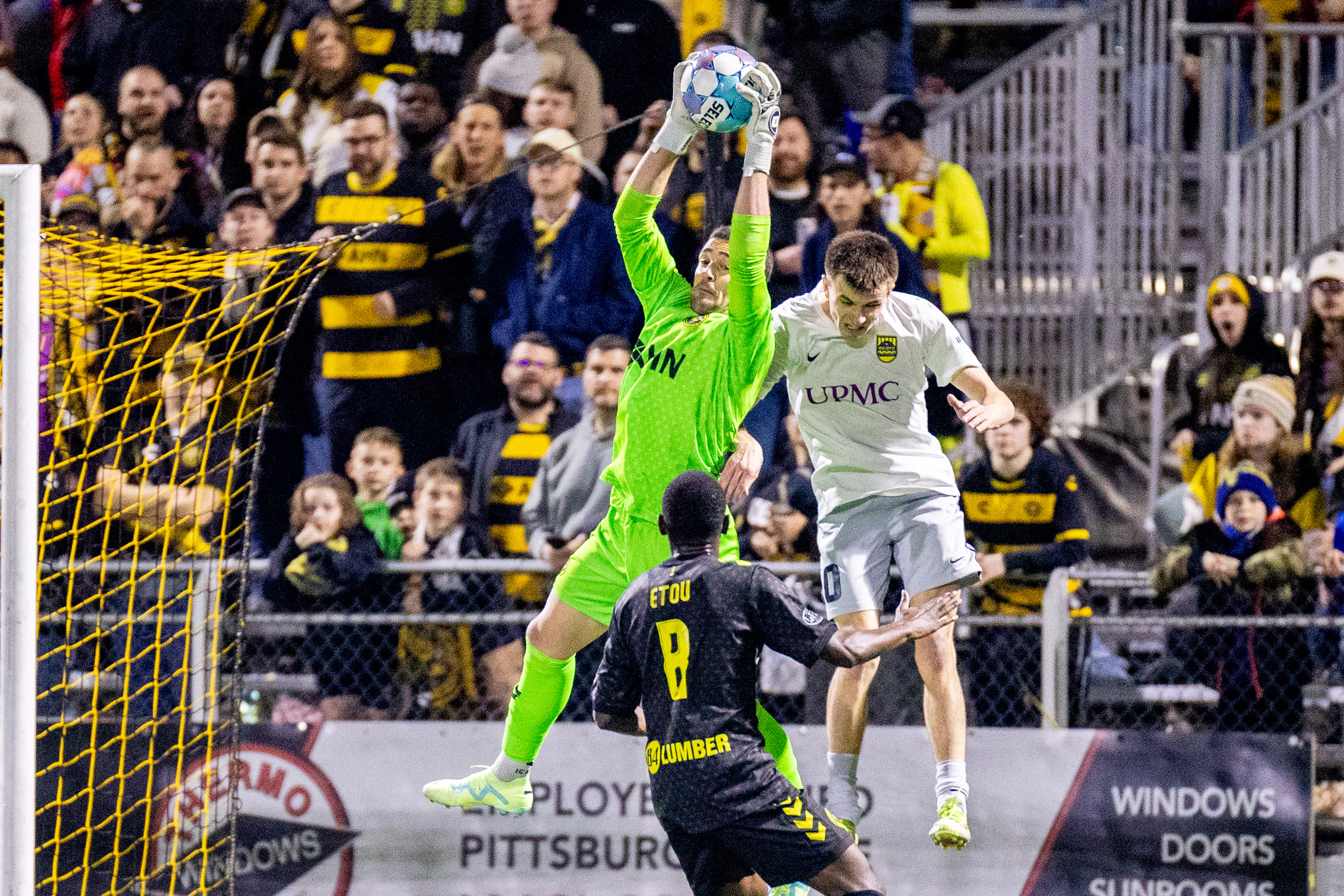 Pittsburgh Riverhounds goalkeeper Nico Campuzano elevates to catch the ball in front of Steel City FC's Nick Graeca in the Hounds' 2-1 win in the U.S. Open Cup First Round on March 25, 2026 at Highmark Stadium in Pittsburgh. (Photo: Chris Cowger/Riverhounds SC)