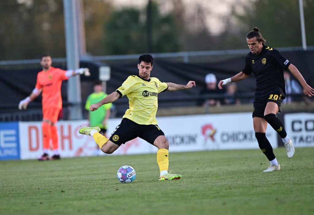 Pittsburgh Riverhounds defender Beto Ydrach clears the ball under pressure from the Charleston Battery's Miguel Berry in the teams' season opener March 7, 2026 at Patriots Point in Mt. Pleasant, S.C. (Photo: Charleston Battery)