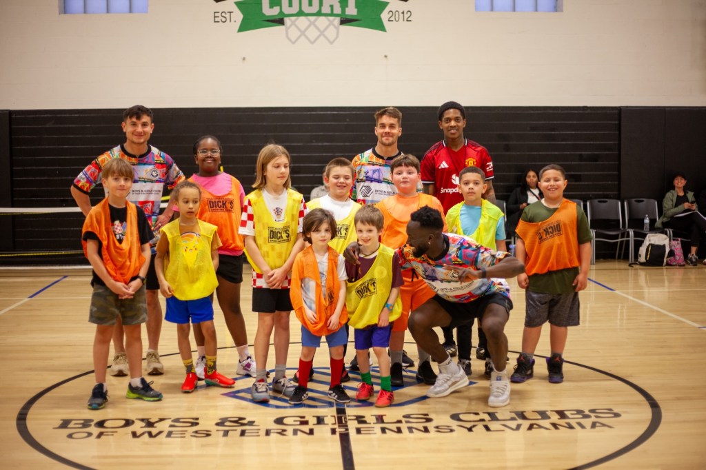 Pittsburgh Riverhounds players Danny Griffin, Robbie Mertz and Albert Dikwa pose for a photo after playing soccer with children at the Boys & Girls Clubs of Western Pennsylvania's Shadyside Clubhouse. (Photo: Mia Olivares/Boys & Girls Clubs of W. Pa.)