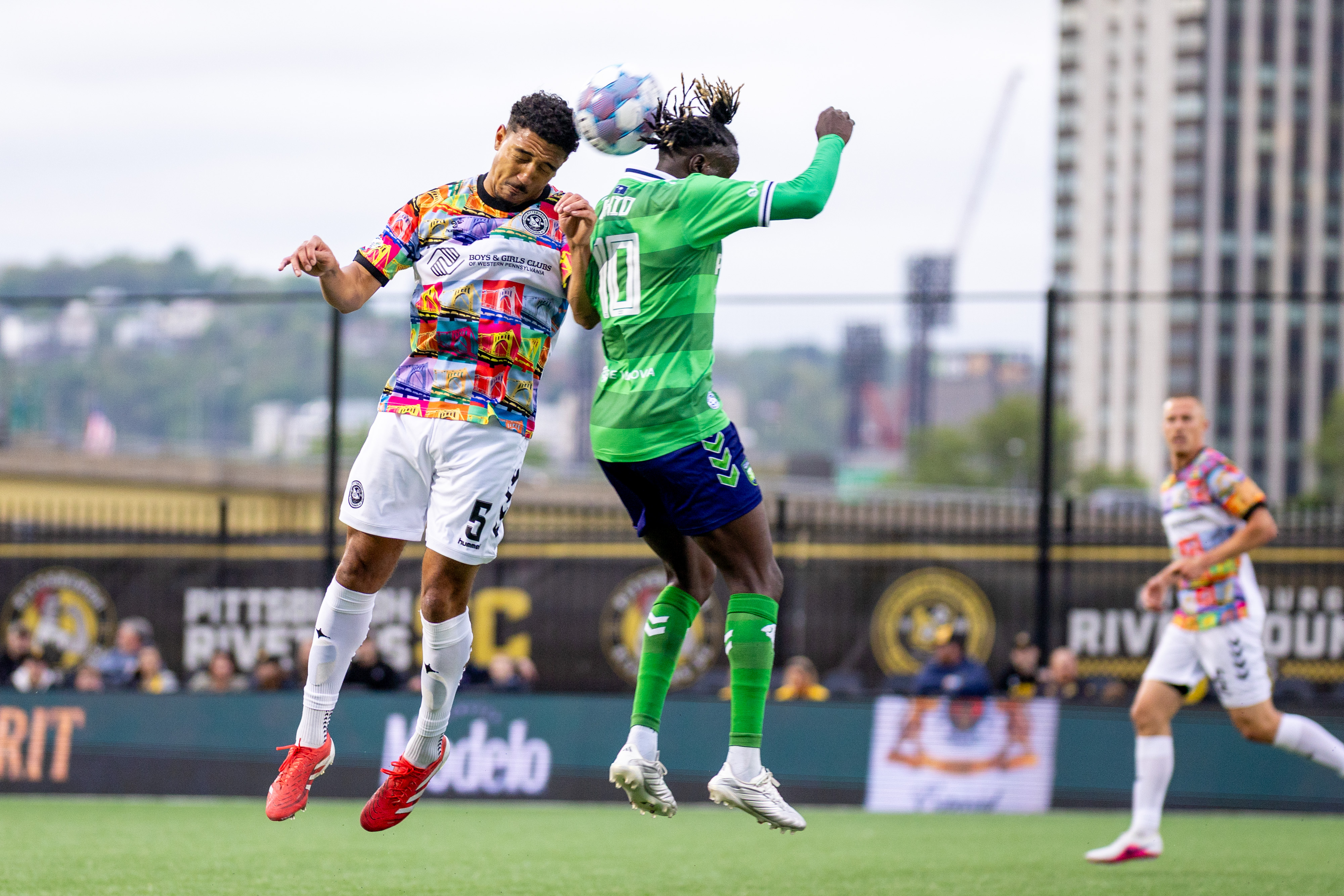 Victor Souza challenges for a header with William Akio of the Greenville Triumph in the Pittsburgh Riverhounds' 3-0 win on April 25, 2026 at F.N.B. Stadium. (Photo: Chris Cowger/Riverhounds SC)
