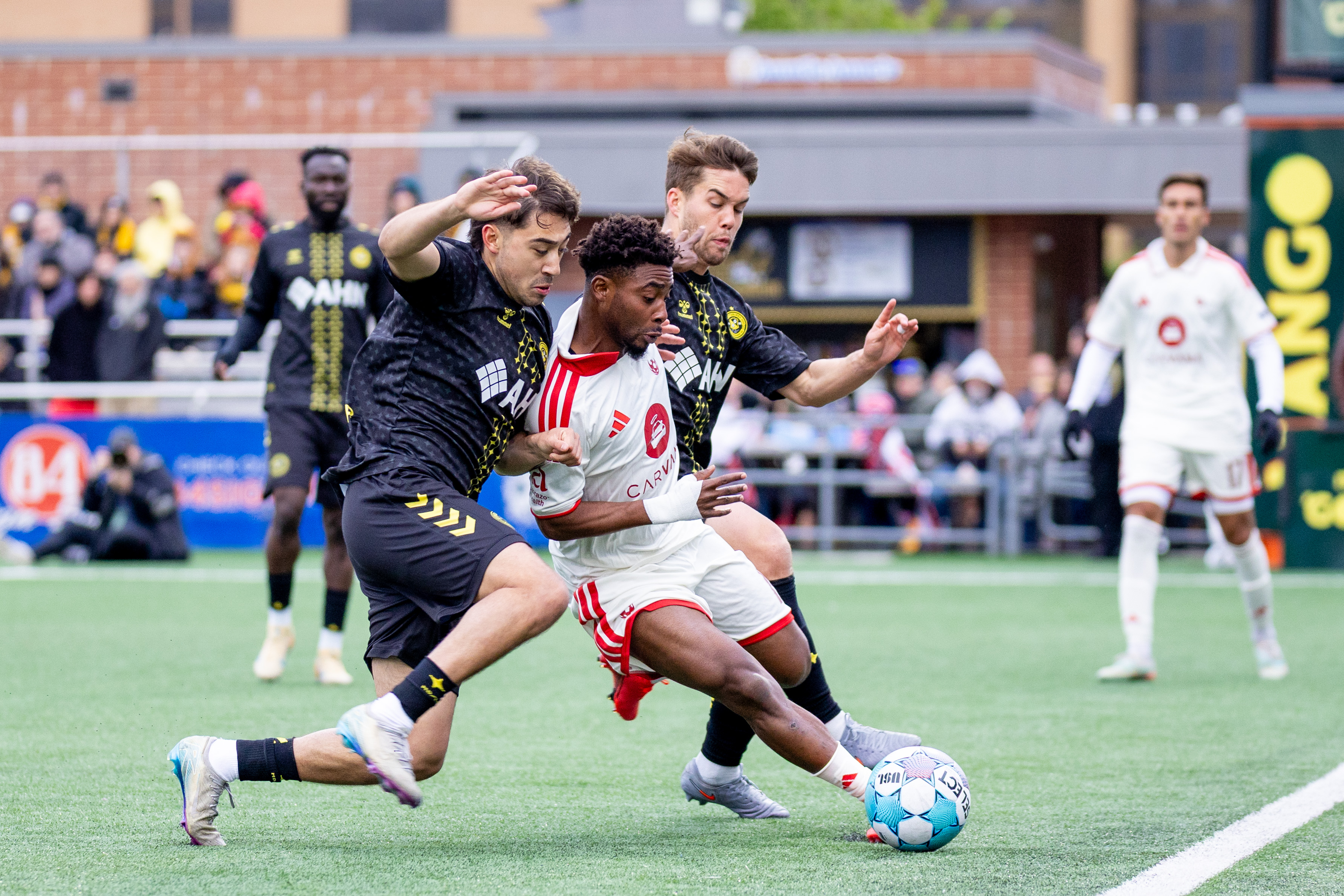 Pittsburgh Riverhounds Max Viera (left) and Robbie Mertz close on Phoenix Rising FC's Hope Avayevu in the teams' match on May 2, 2026 at F.N.B. Stadium in Pittsburgh. (Photo: Chris Cowger/Riverhounds SC)