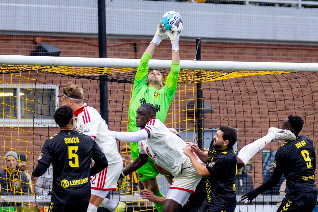 Pittsburgh Riverhounds goalkeeper Nico Campuzano rises above a crowd of players to catch a corner kick in the team's match against Phoenix Rising FC on May 2, 2026 at F.N.B. Stadium in Pittsburgh. (Photo: Chris Cowger/Riverhounds SC)