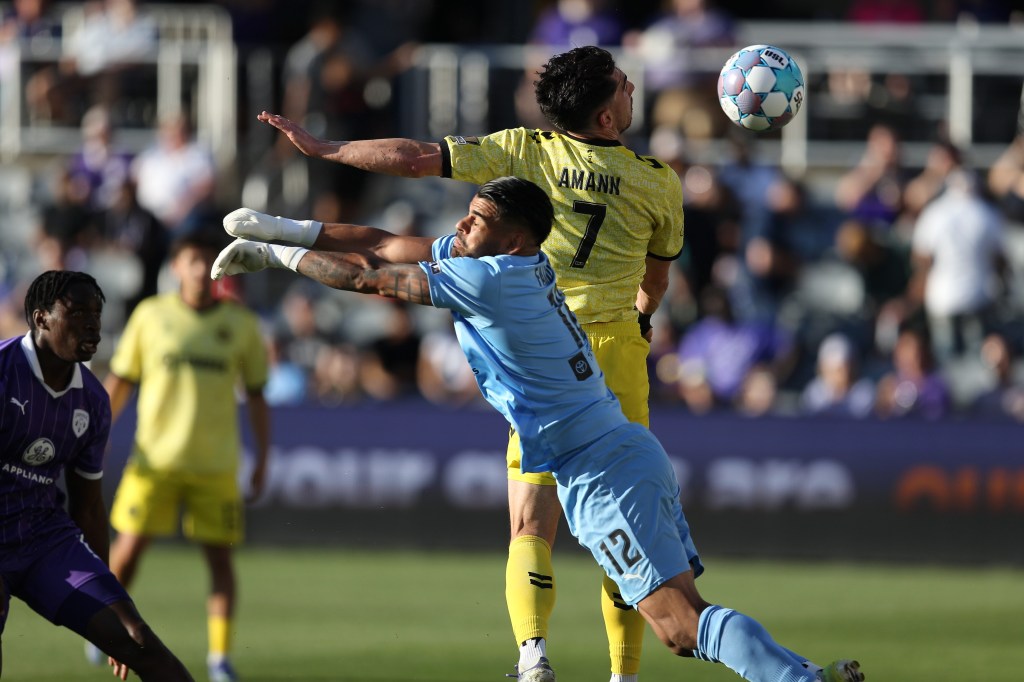 Trevor Amann scores with a header in front of Louisville City FC goalkeeper Danny Faundez in the Pittsburgh Riverhounds' 2-0 win on May 9, 2026 at Lynn Family Stadium in Louisville, Ky. (Photo: EM Dash Photography/Louisville City FC)