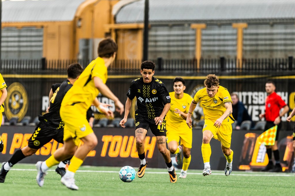 Israel Neto dribbles the ball toward goal in the Pittsburgh Riverhounds 2 win over Erie Sports Center, 2-0, in a USL League Two match on May 21, 2026 at F.N.B. Stadium in Pittsburgh.