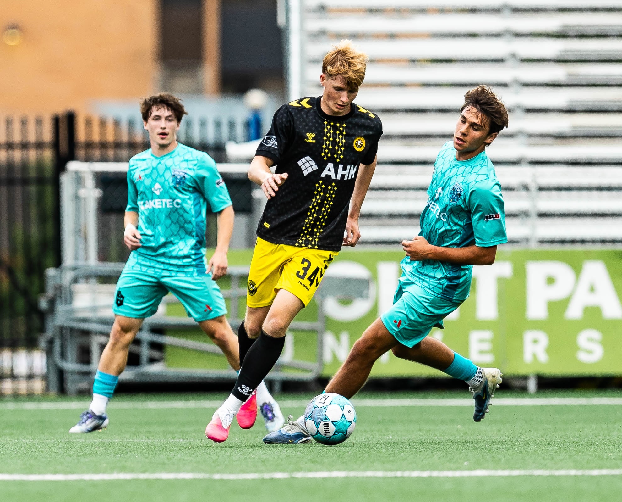 Daniel Firek turns away from a pair of Lorain County Leviathan defenders in Pittsburgh Riverhounds 2's victory June 17, 2026 at F.N.B. Stadium. (Photo: Mallory Neil/Riverhounds SC)