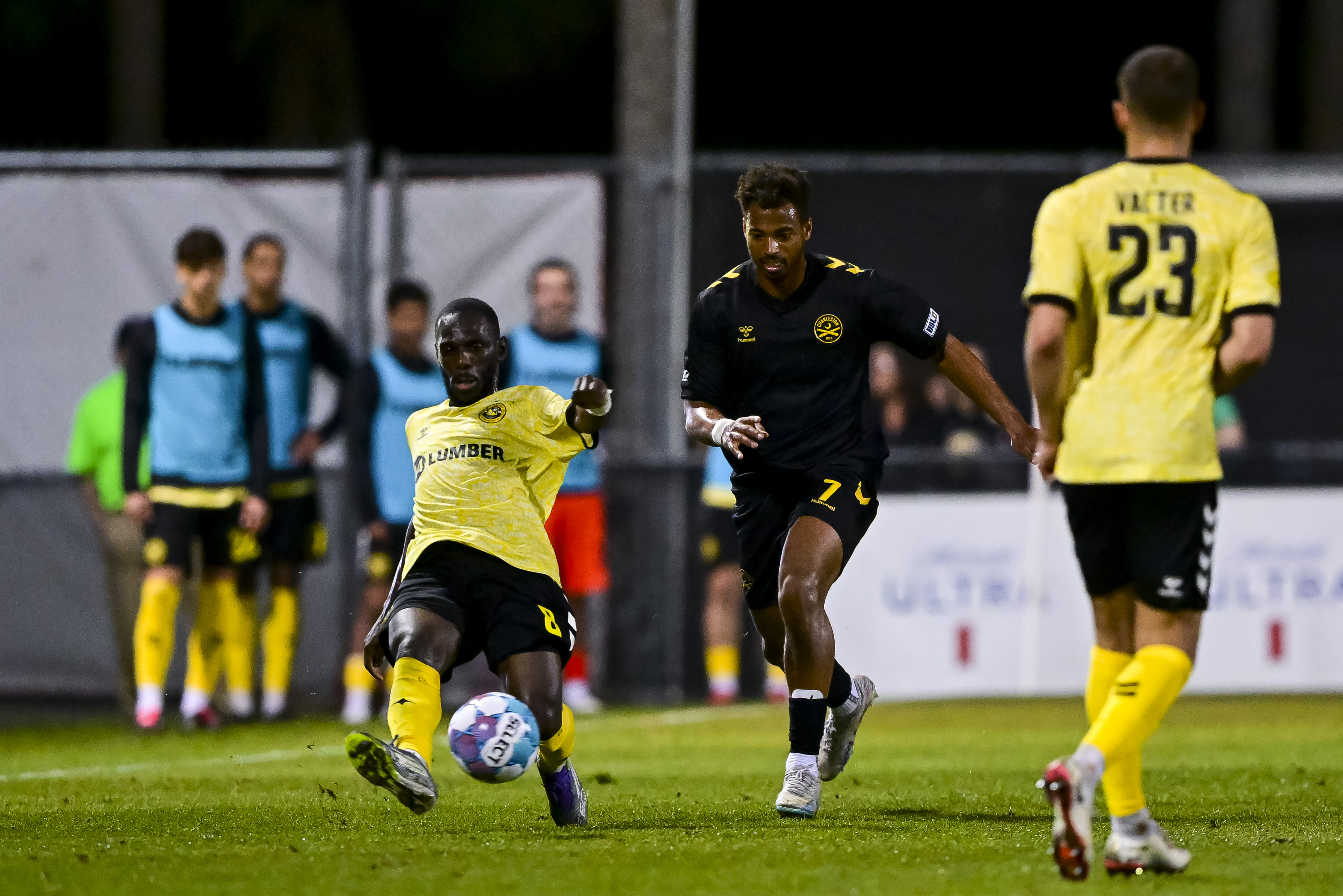 Pittsburgh Riverhounds wing back Junior Etou lunges to play the ball ahead of the Charleston Battery's Langston Blackstock in the teams' match March 7, 2026 at Patriots Point Soccer Complex in Mount Pleasant, S.C. (Photo: Charleston Battery)