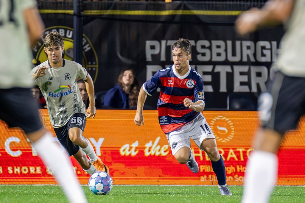 Robbie Mertz dribbles between defenders in the Pittsburgh Riverhounds' match against Brooklyn FC on July 4, 2026 at F.N.B. Stadium in Pittsburgh. (Photo: Chris Cowger/Riverhounds SC)