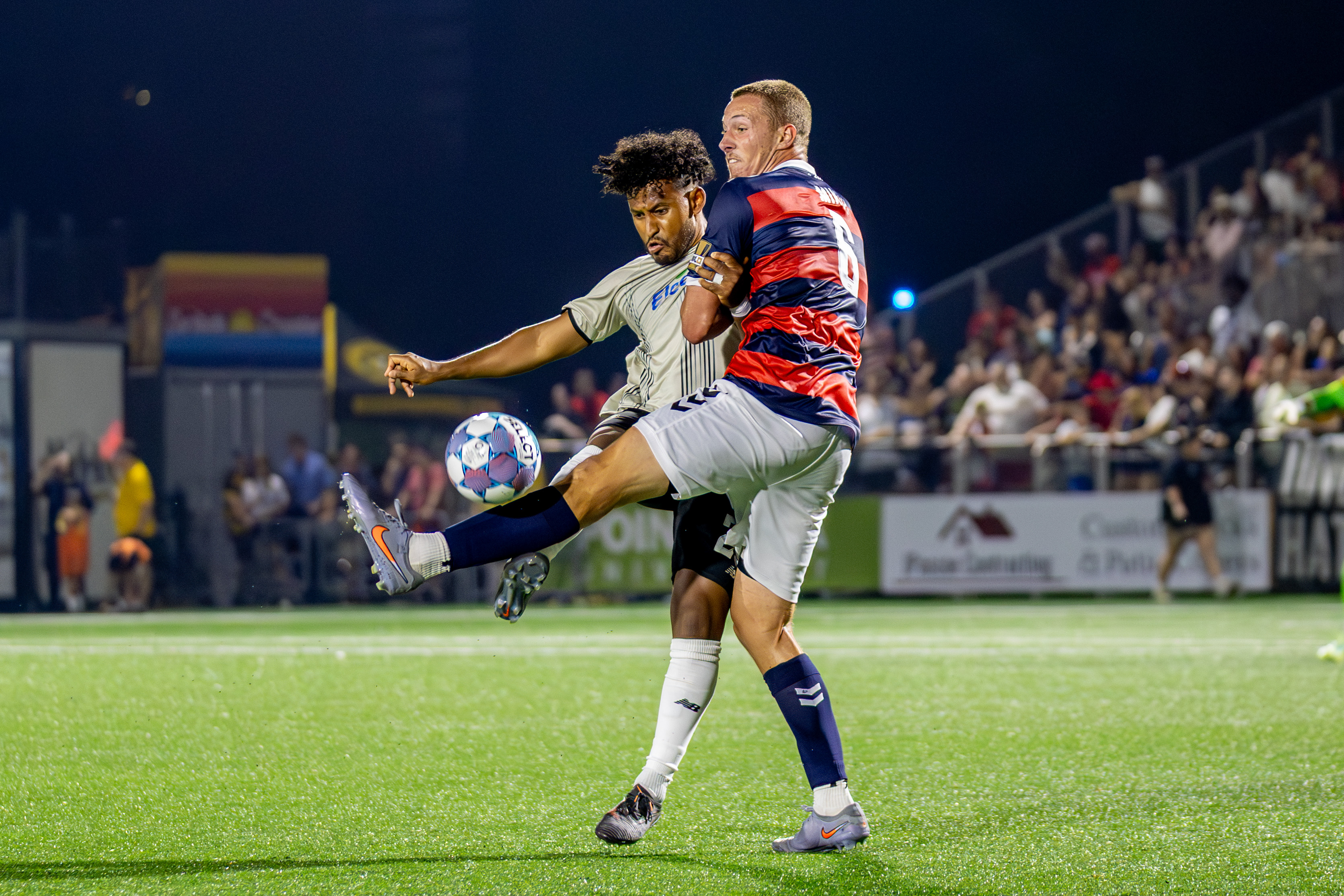 Pittsburgh Riverhounds defender Owen Mikoy tangles with Brooklyn FC forward J.C. Obregón in the teams' match July 4, 2026 at F.N.B. Stadium. (Photo: Chris Cowger/Riverhounds SC)