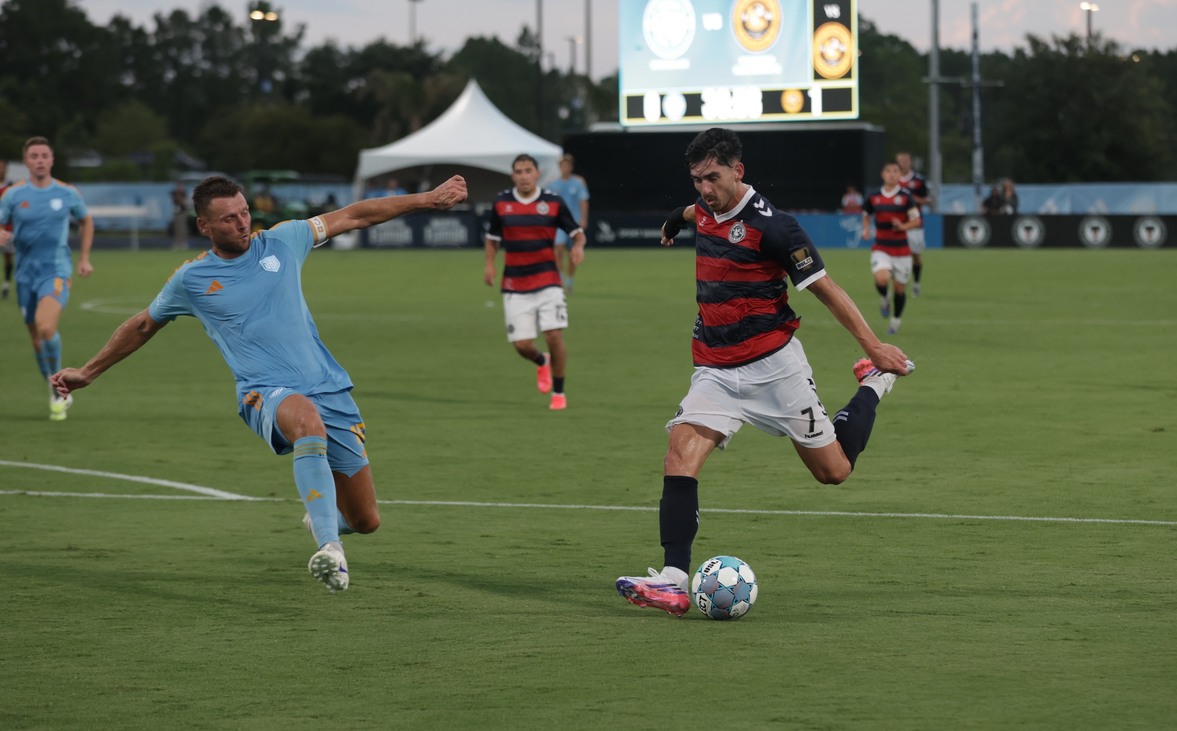 Trevor Amann shoots around Sporting Jacksonville defender Ryan Edwards in the Pittsburgh Riverhounds' match on July 15, 2026 at Hodges Stadium in Jacksonville, Fla. (Photo: Sporting Club Jacksonville)