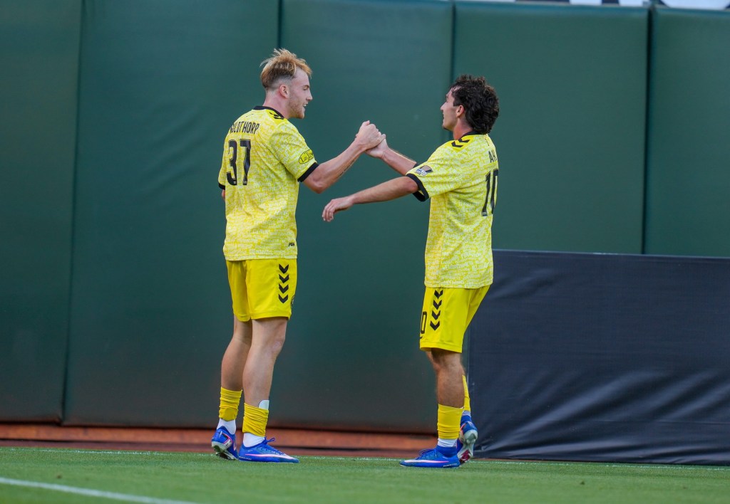 Charles Ahl (right) congratulates Eliot Goldthorp after his goal in the Pittsburgh Riverhounds' 1-0 win over Oakland Roots SC on Aug. 1, 2026 at Oakland-Alameda County Coliseum in Oakland, Calif. (Photo: Oakland Roots SC)